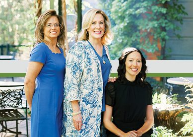 Donna, Jacqueline, and Karla in a team photo outside during the day